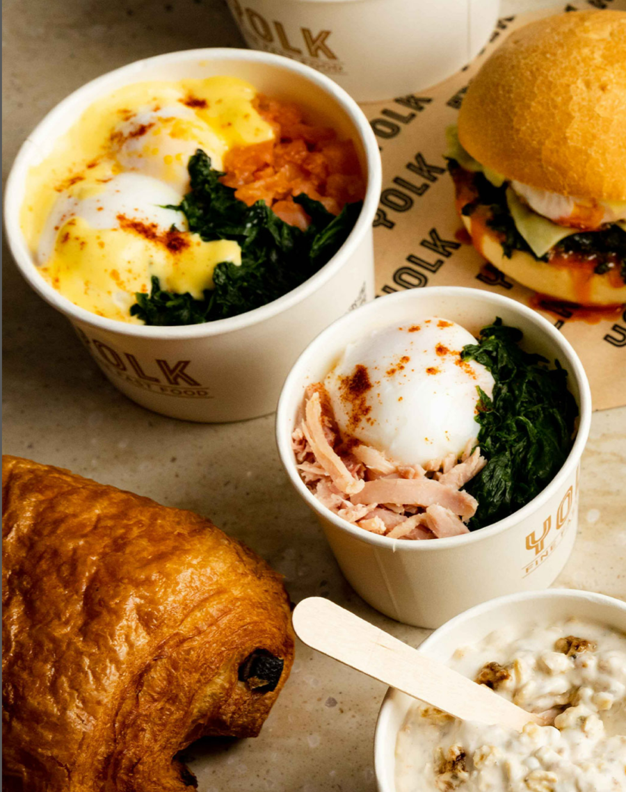 Two poached egg pots, pastries, and a breakfast roll from Yolk.